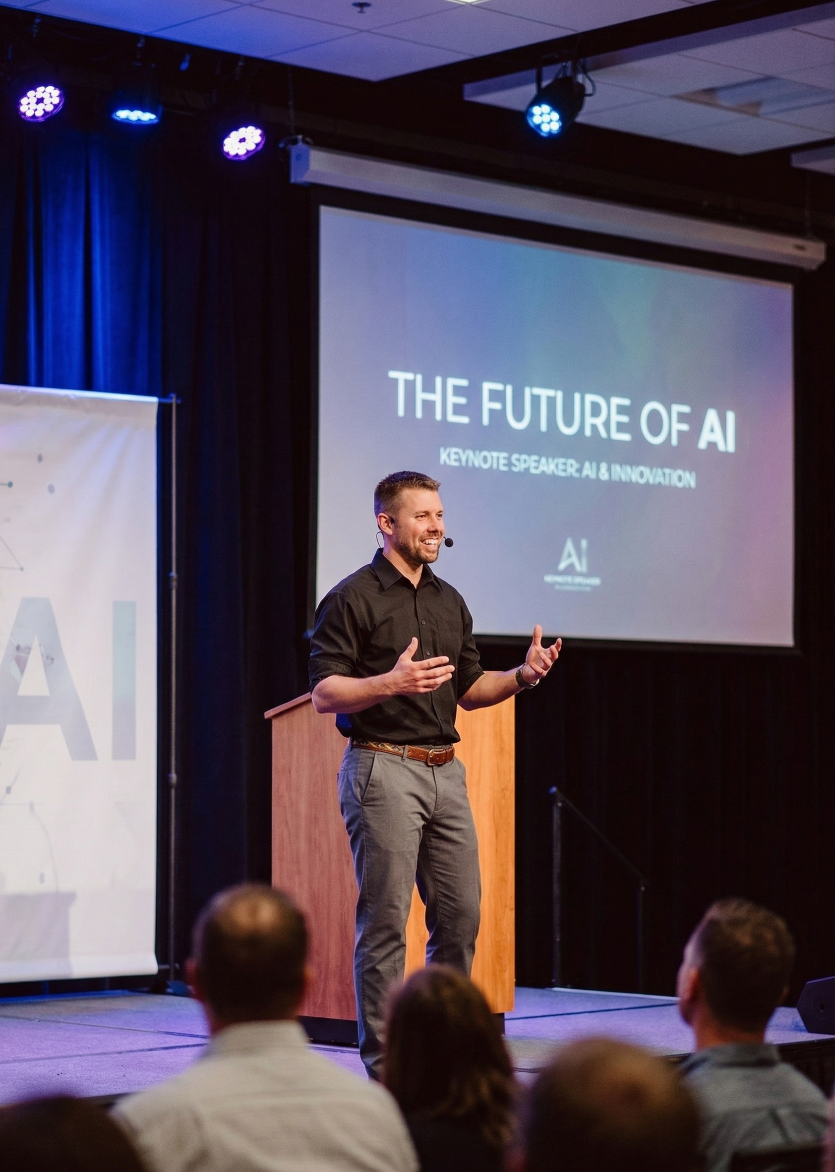 Peter Denbigh speaking on stage